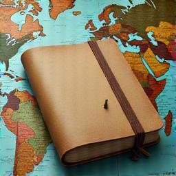 Travel guide notebook on map
